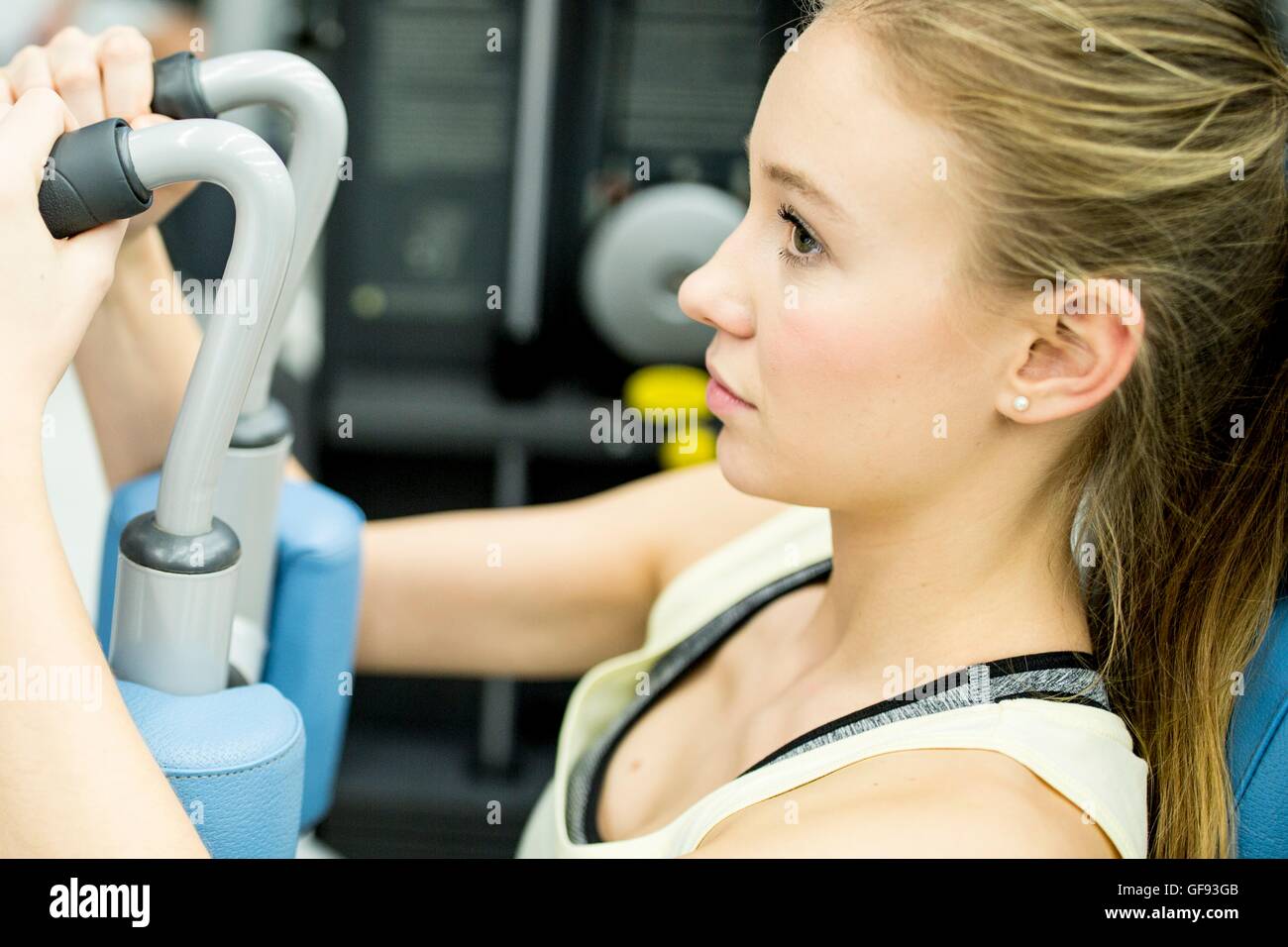 Proprietà rilasciato. Modello rilasciato. Giovane donna con macchina a farfalla in palestra. Foto Stock