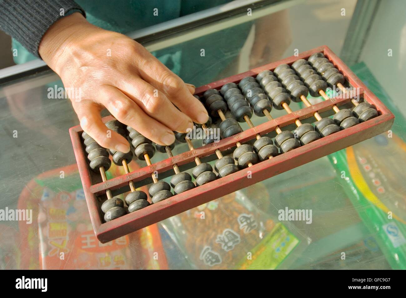 Abacus Macchina di conteggio calcolatrice. donna mano utilizzando abacus aggiungendo la sottrazione di somma sul banco di negozio in negozio cinese, Cina Foto Stock Abacus Macchina di conteggio calcolatrice. donna mano utilizzando abacus aggiungendo la sottrazione di somma sul banco di negozio in negozio cinese, Cina Foto Stock