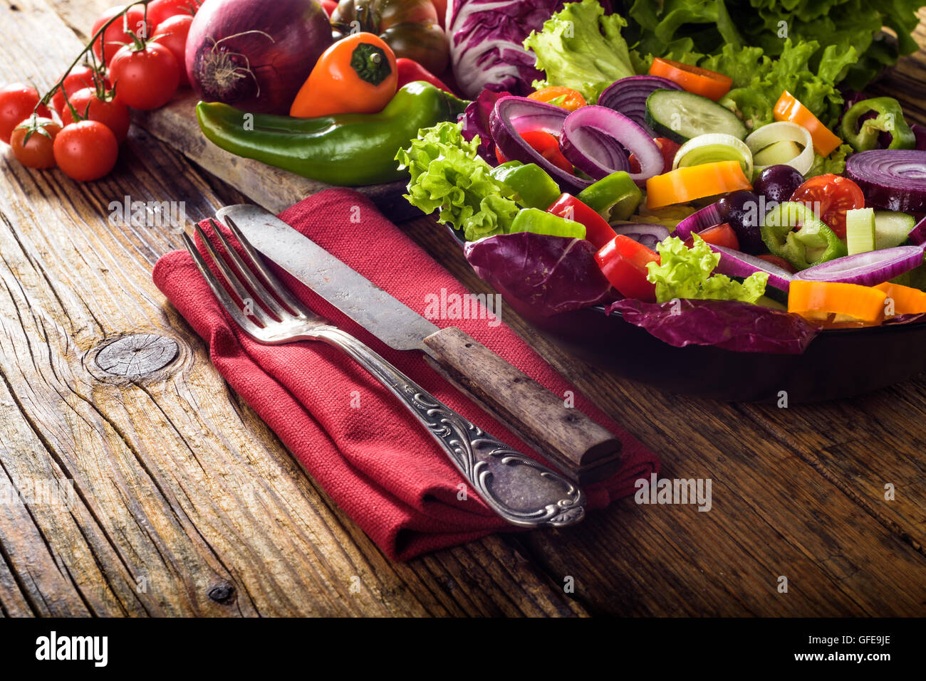 Insalata primaverile con fresche verdure succose su una tavola in legno rustico. Foto Stock
