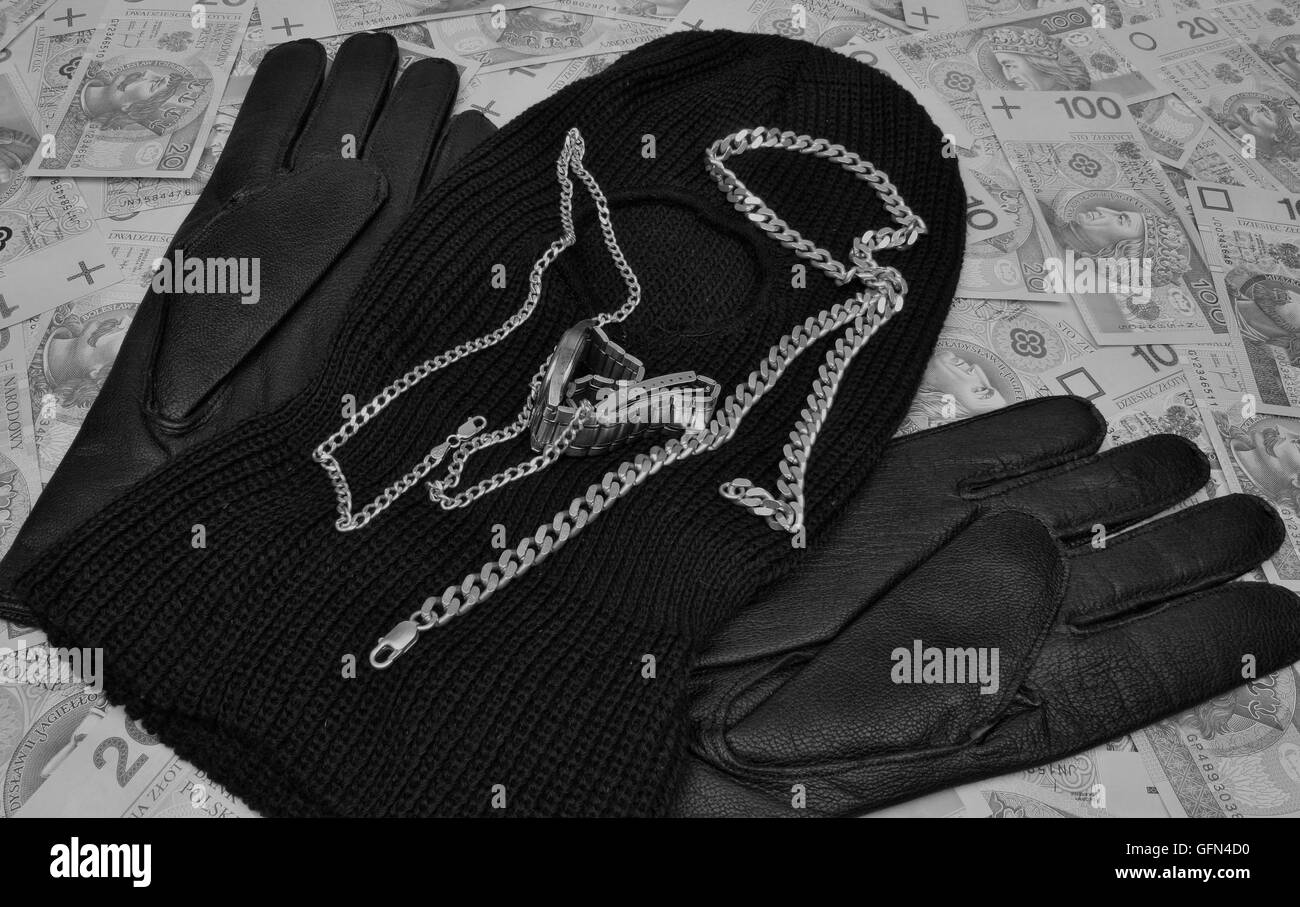 Cose bandit pistola penale, passamontagna, guanti, polacco di denaro sul tavolo Foto Stock