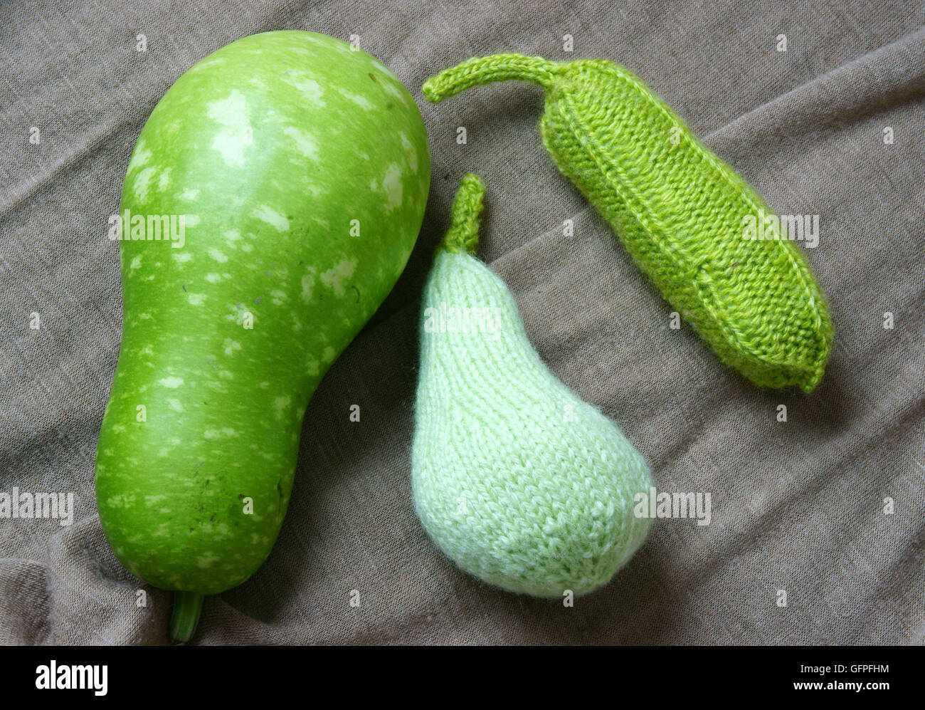 Attività di svago a casa con maglieria, gruppo di verdure colorate a maglia e frutta come carota, arancia, cetriolo per l'arredamento per la cucina Foto Stock