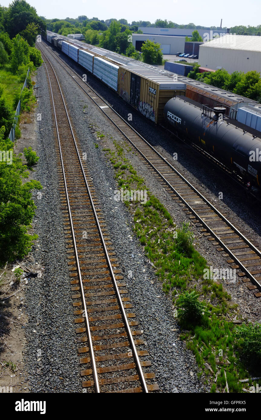 I treni merci passando un vuoto che la linea ferroviaria nella città canadese di London, Ontario. Foto Stock