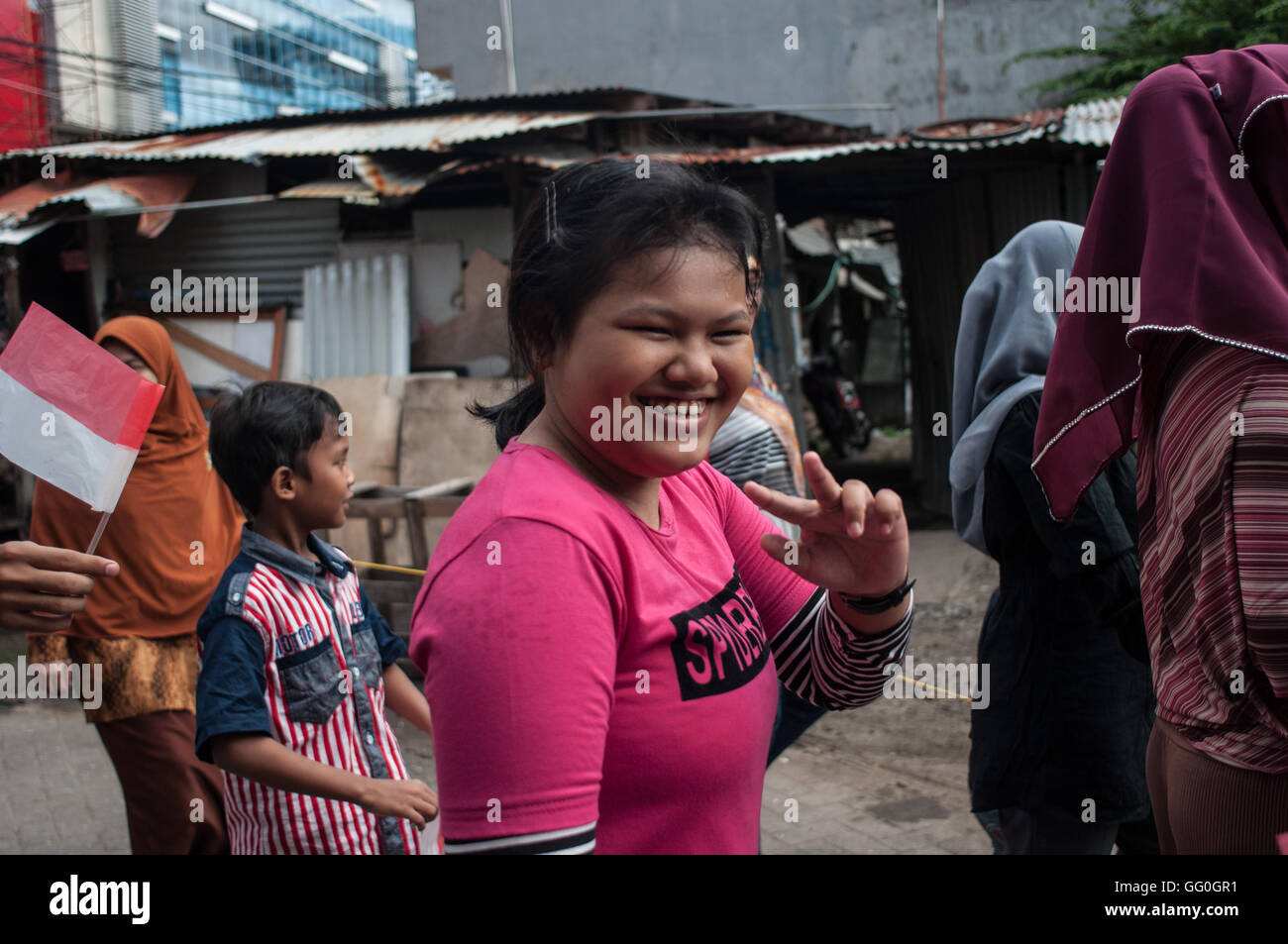 Una bambina autistica sorrisi durante il mese di marzo nei pressi di Tempat Pelatihan Harapan (formazione del Centro Speranza) in Makassar, Indonesia. Foto Stock