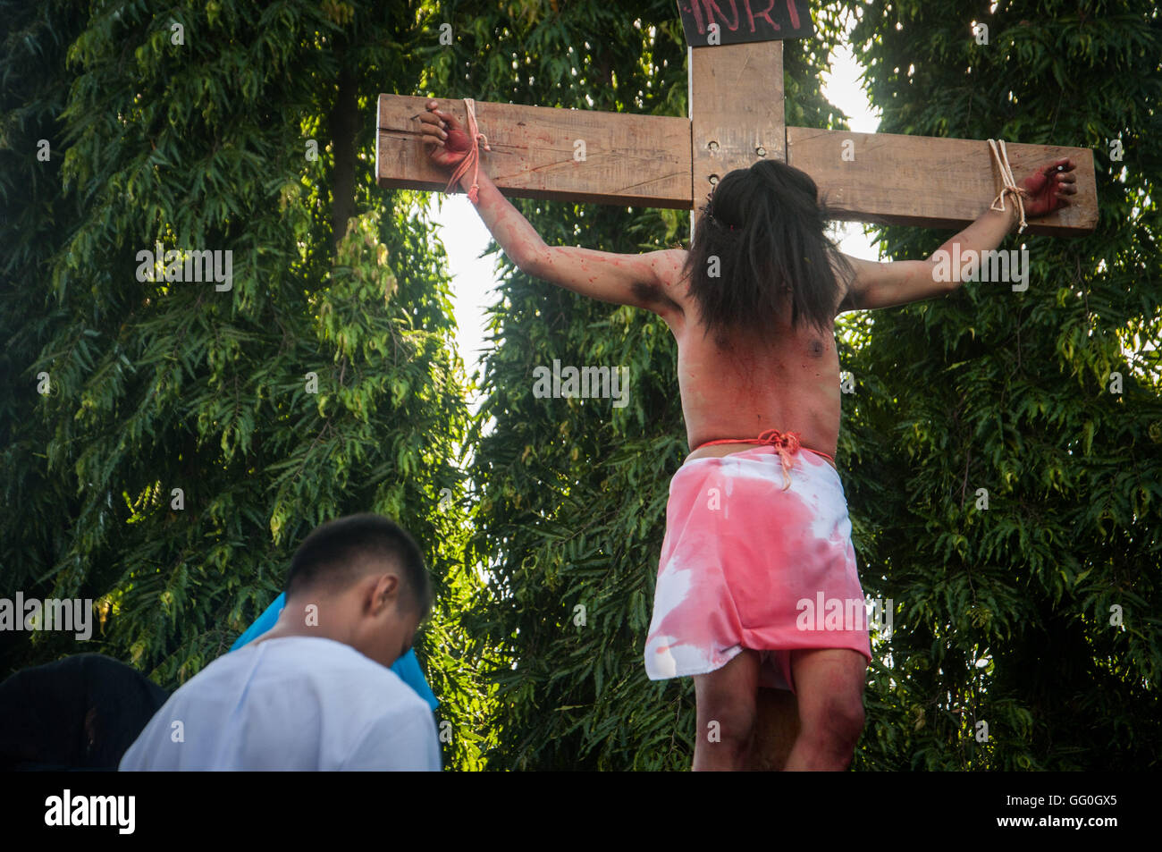 Cristiani indonesiani prendere parte alla rievocazione storica di Gesù Cristo Crocifissione in Santa Maria Regina del Rosario chiesa. La processione Foto Stock