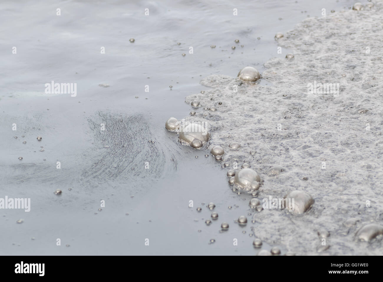 Inquinamento di acqua nel fiume perché non industriali trattare l' acqua prima dello scarico. Foto Stock