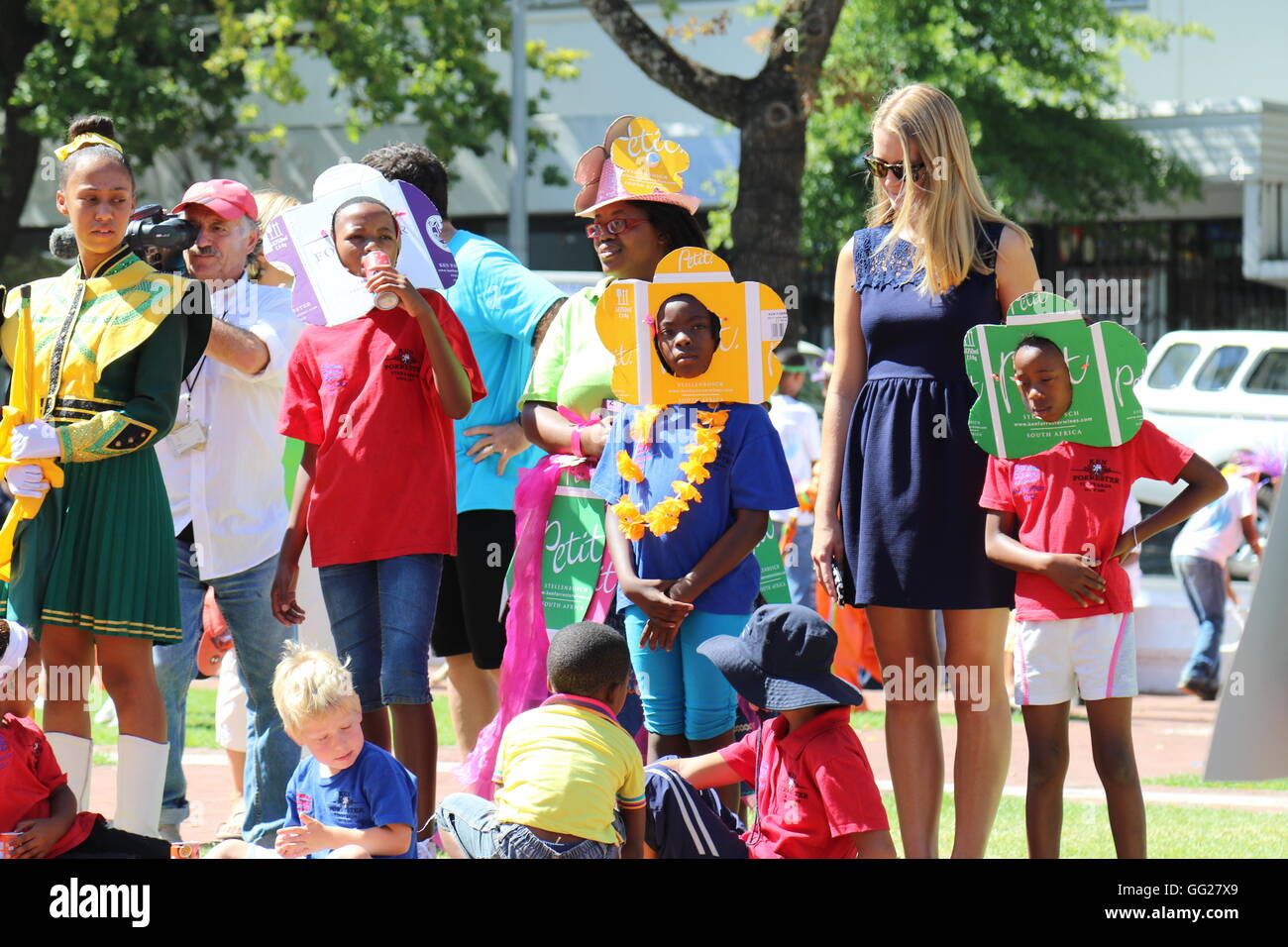 La gente per strada con i suoi colorati costumi e maschere viso al 2016 Stellenbosch wine parade Foto Stock