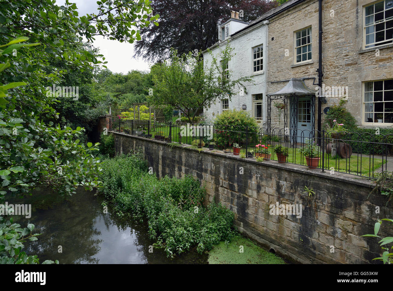 Vecchie case accanto al fiume Frome, Porta Brimscombe, Stroud, Gloucestershire Foto Stock