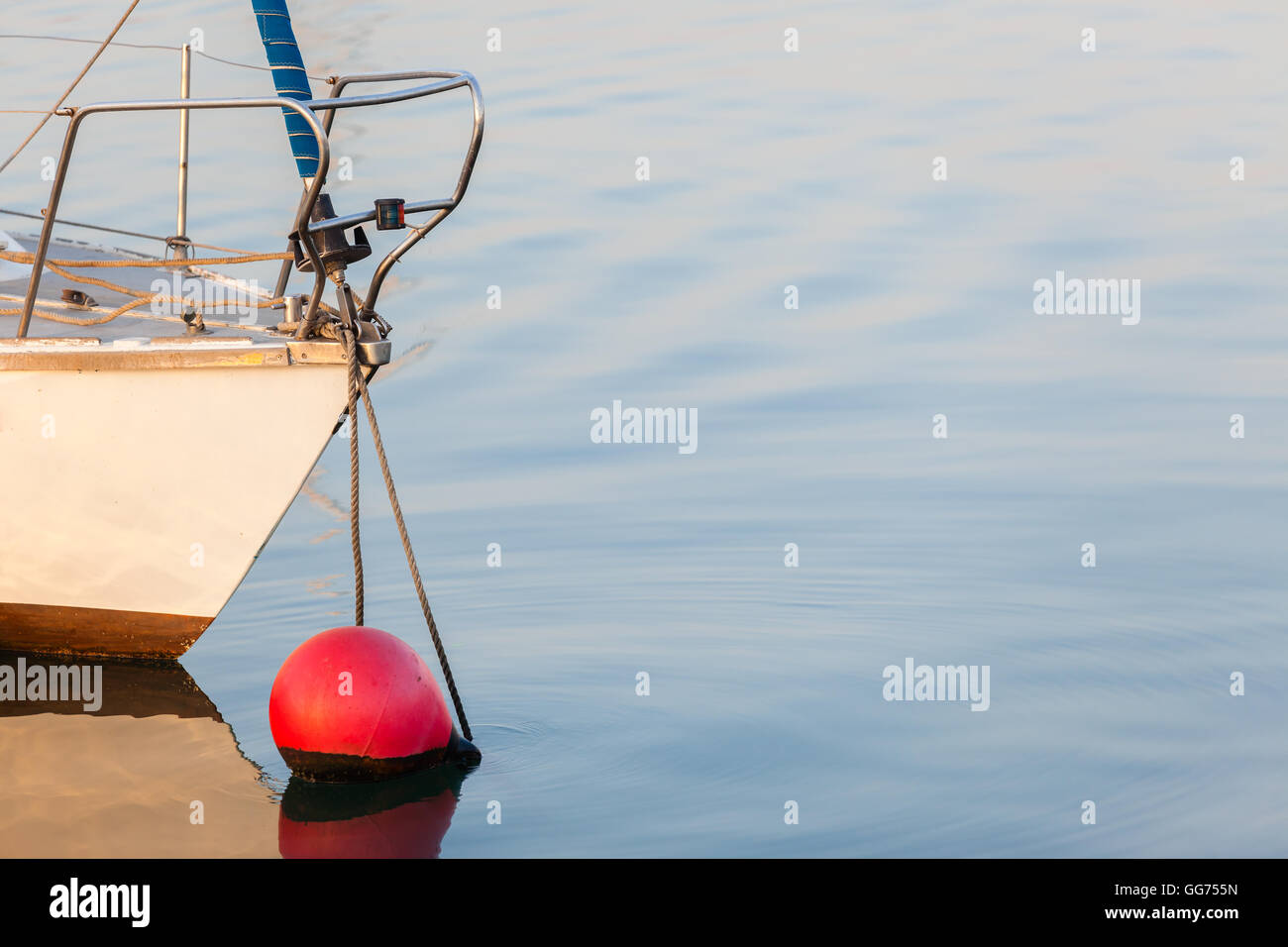 Yacht sezione prodiera boa ancorata sul mare vetroso di acqua oceanica. Foto Stock