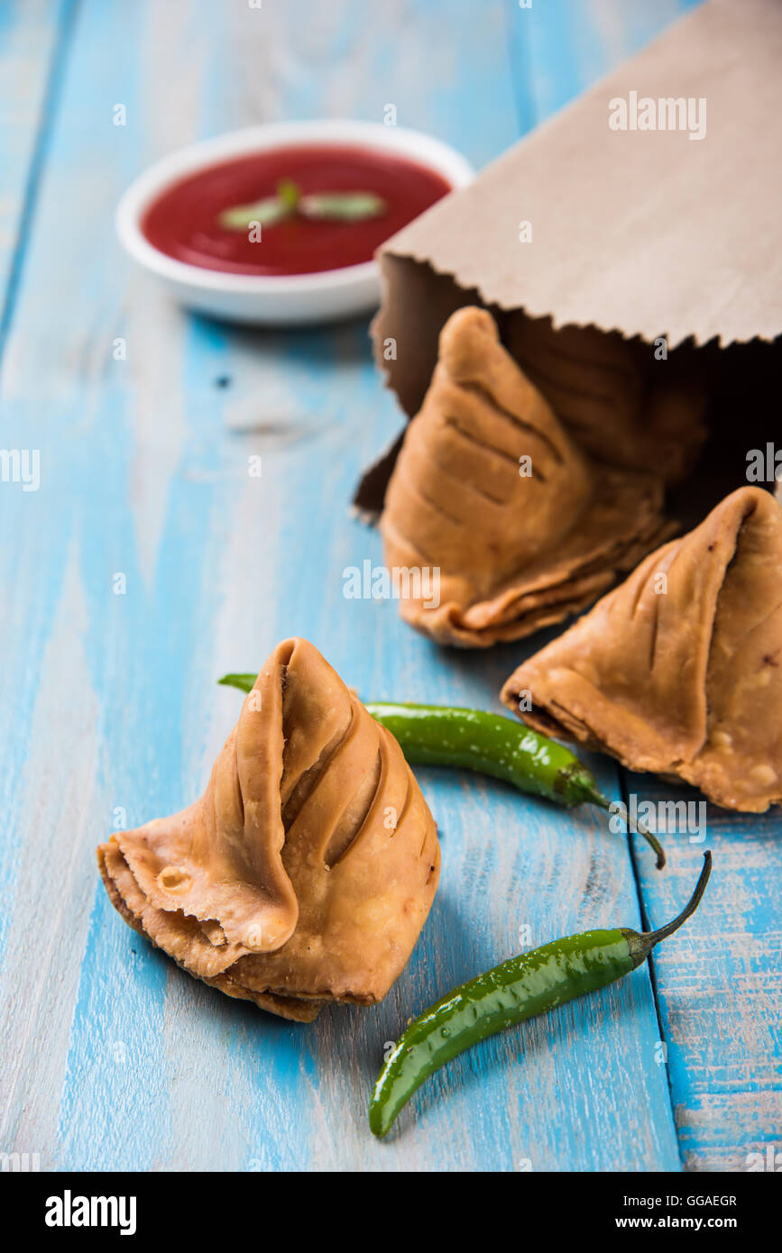 Samosa snack di ketchup e tè caldo, fresco samosas con ketchup e caldo chai pronti per la prima colazione Foto Stock