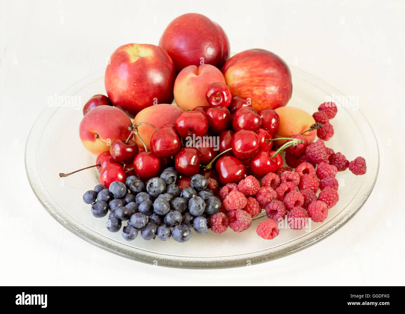 Piatto di vetro con una varietà di frutta estiva Foto Stock
