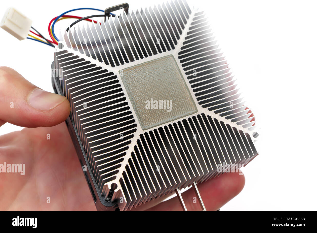 Computer dissipatore di calore della CPU e la pasta termica in mano Foto Stock