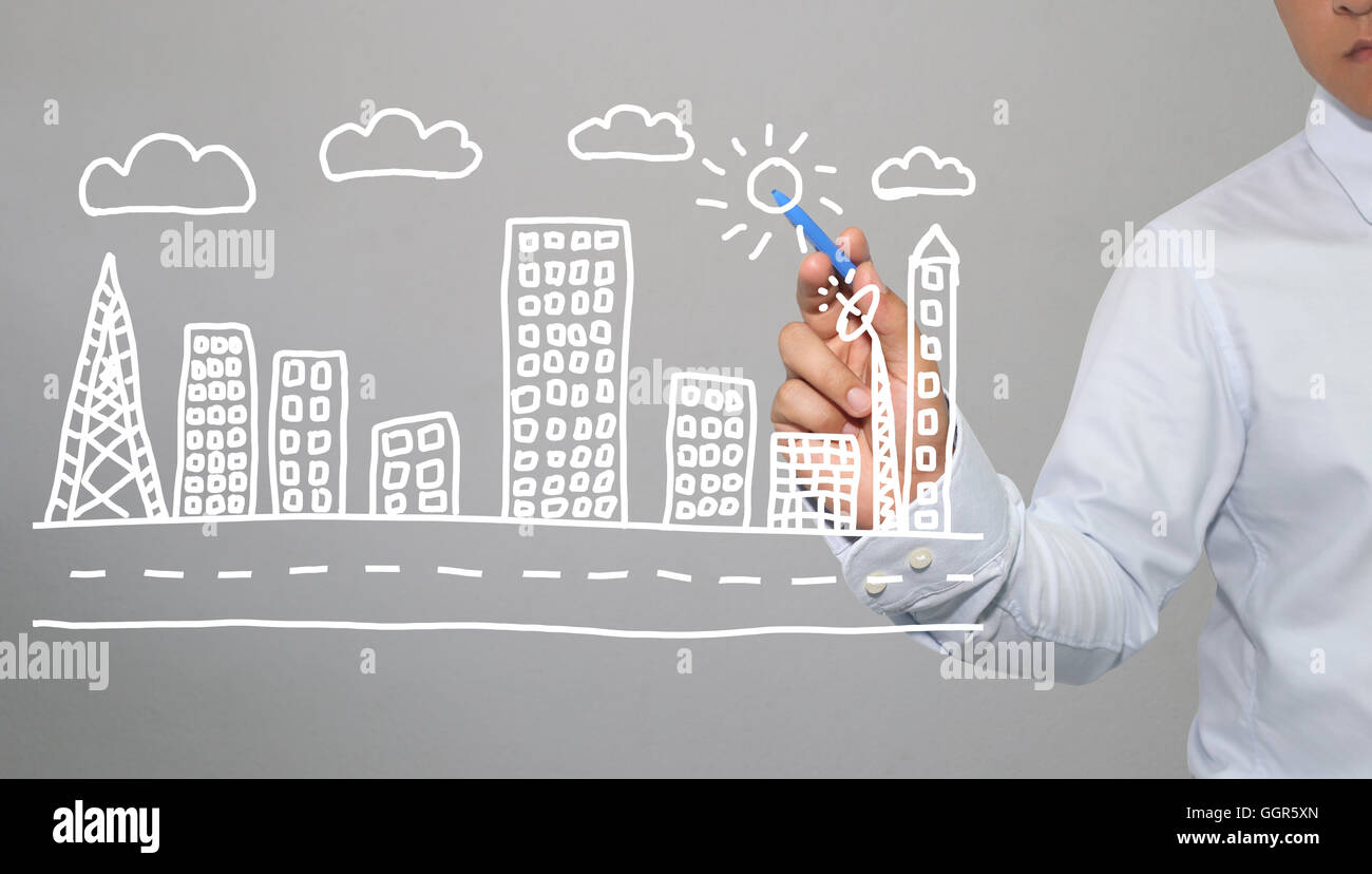 Mano di imprenditore di grafica di disegno a simboli forme geometriche della città e del grattacielo di edifici nel concetto di business e hanno Foto Stock