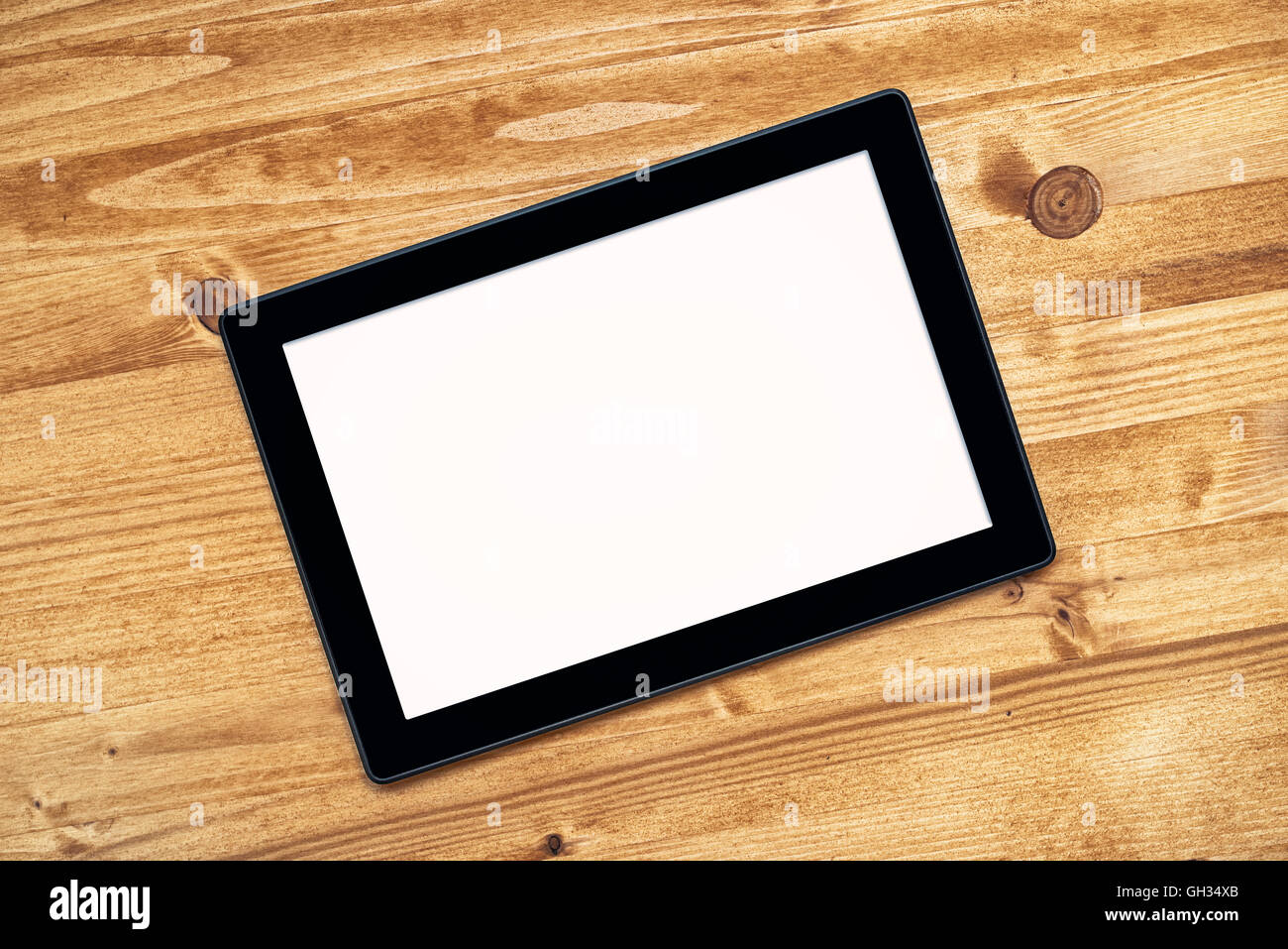 Tablet PC con il bianco schermo vuoto come copia di spazio sulla scrivania in ufficio, vista dall'alto Foto Stock