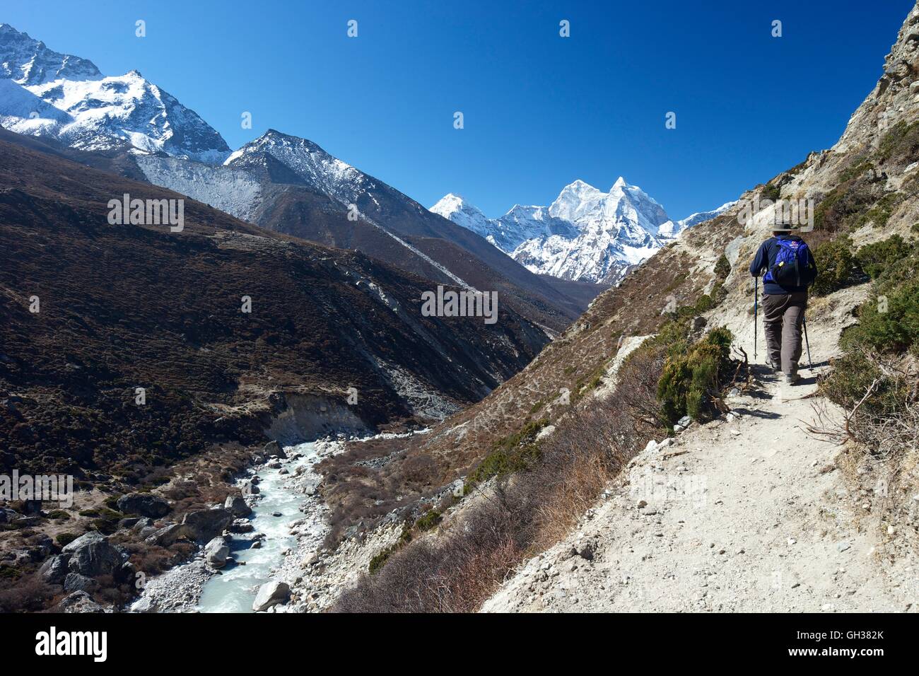 Trekker sul Passo di Pheriche con Ama Dablam in lontananza, Parco Nazionale di Sagarmatha, Distretto di Solukhumbu, Nepal, Asia Foto Stock