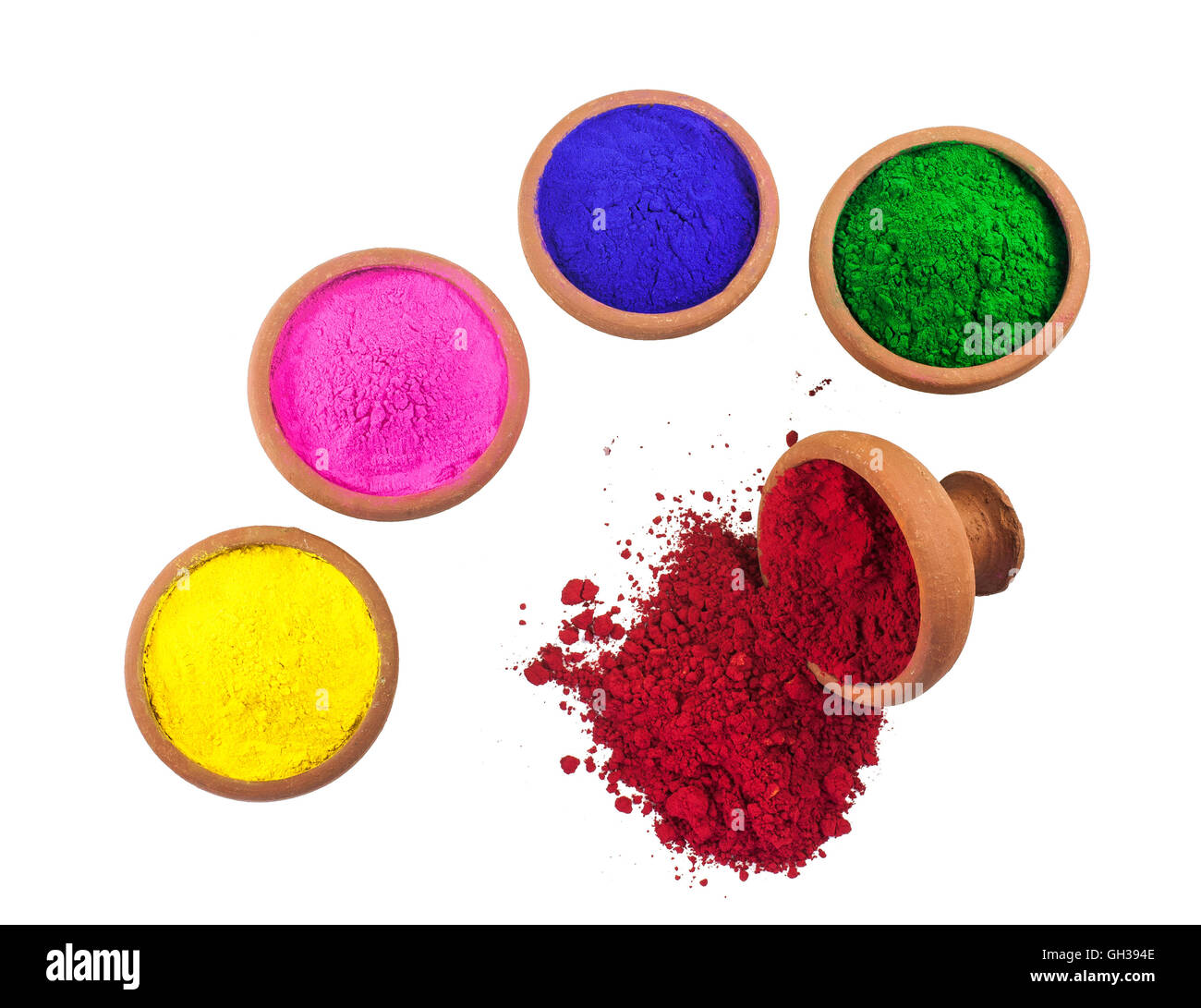 Vari pigmenti colorati in ciotole di terracotta isolati su bianco. Foto Stock
