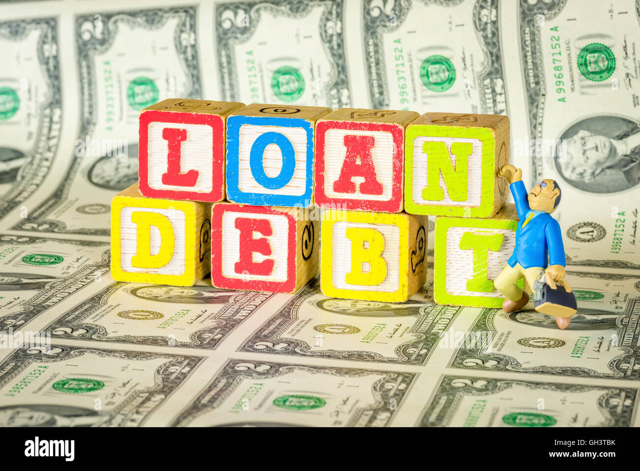 Il debito di prestito e di denaro con toy uomo Foto Stock