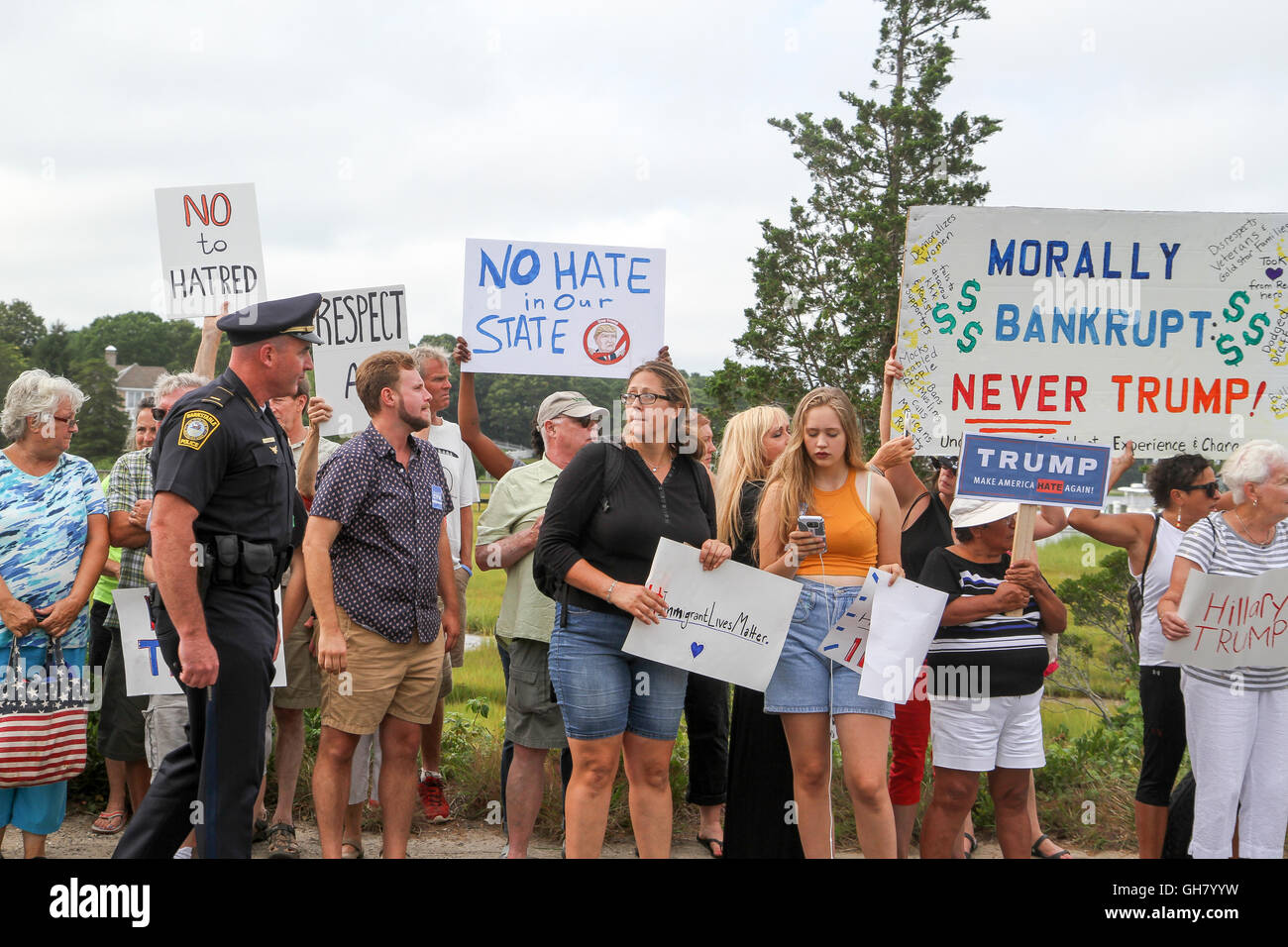 Osterville, Massachusetts, STATI UNITI D'AMERICA. 6 agosto 2016. Manifestanti tenere segni opposti presidenziale repubblicano nominee Donald Trump, nei pressi di un fundraiser imprenditore William Koch hosting per Trump. Credito: Susan Pease/Alamy Live News Foto Stock