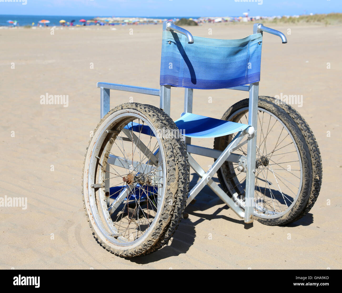 Sedia a rotelle alluminio sulla spiaggia al mare Foto Stock