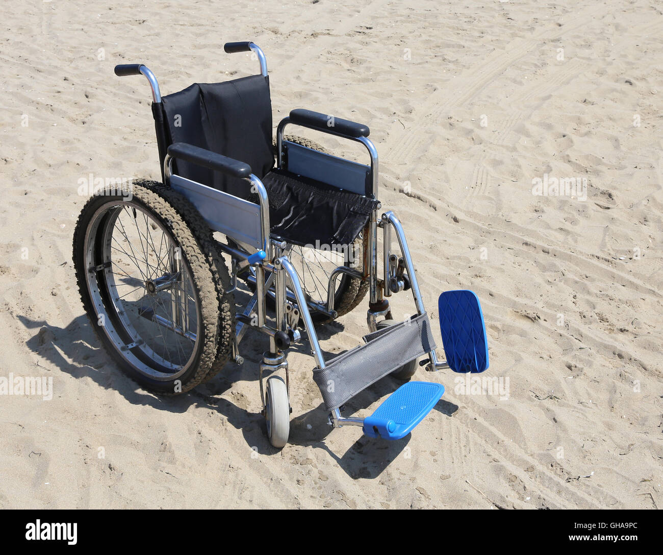 Sedia a rotelle robusto in alluminio con ruote doppie speciali sulla spiaggia Foto Stock