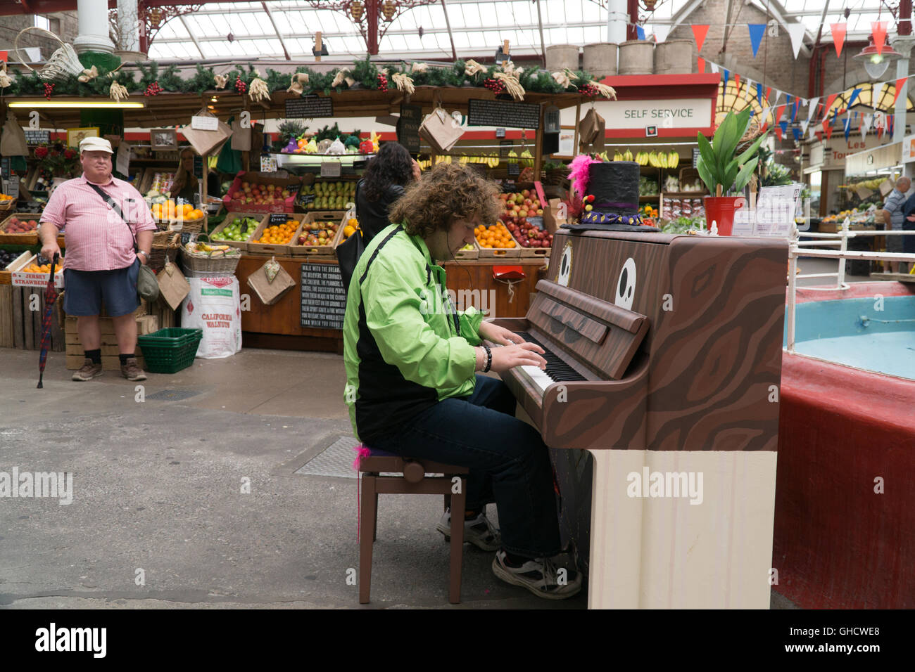 Un vecchio pianoforte suonato da un membro del pubblico nel vecchio stile vittoriano Mercato Centrale,St.helier,jersey,Isole del Canale Foto Stock