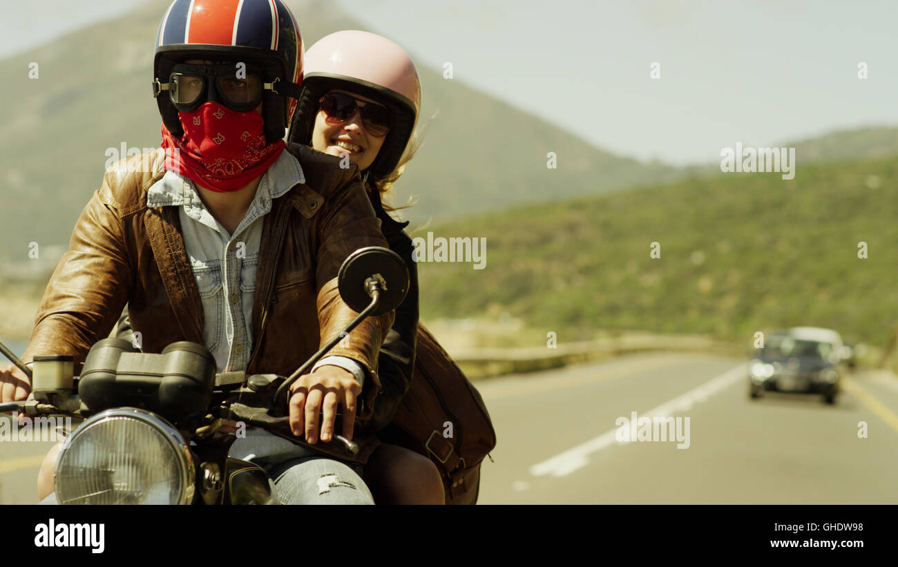 Coppia giovane riding motociclo su sunny road Foto Stock
