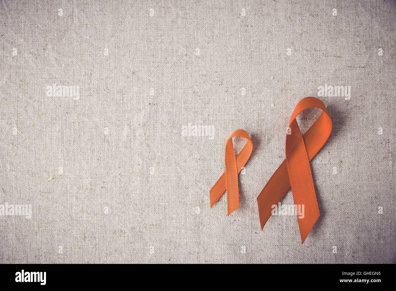 Nastri di colore arancione su sfondo tonificante, leucemia consapevolezza, di per sé pregiudizio Consapevolezza Giorno,sclerosi multipla consapevolezza Foto Stock