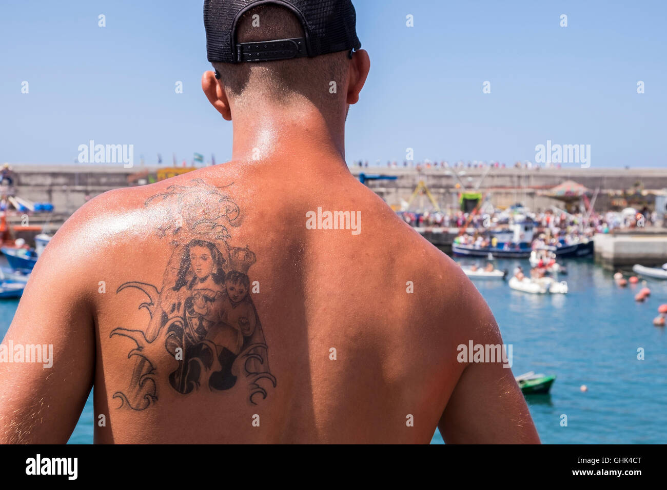 Imbarco della Madonna, Nuestra Señora del Carmen su di una barca da pesca guardato da un giovane uomo con tatuaggio della vergine e Foto Stock