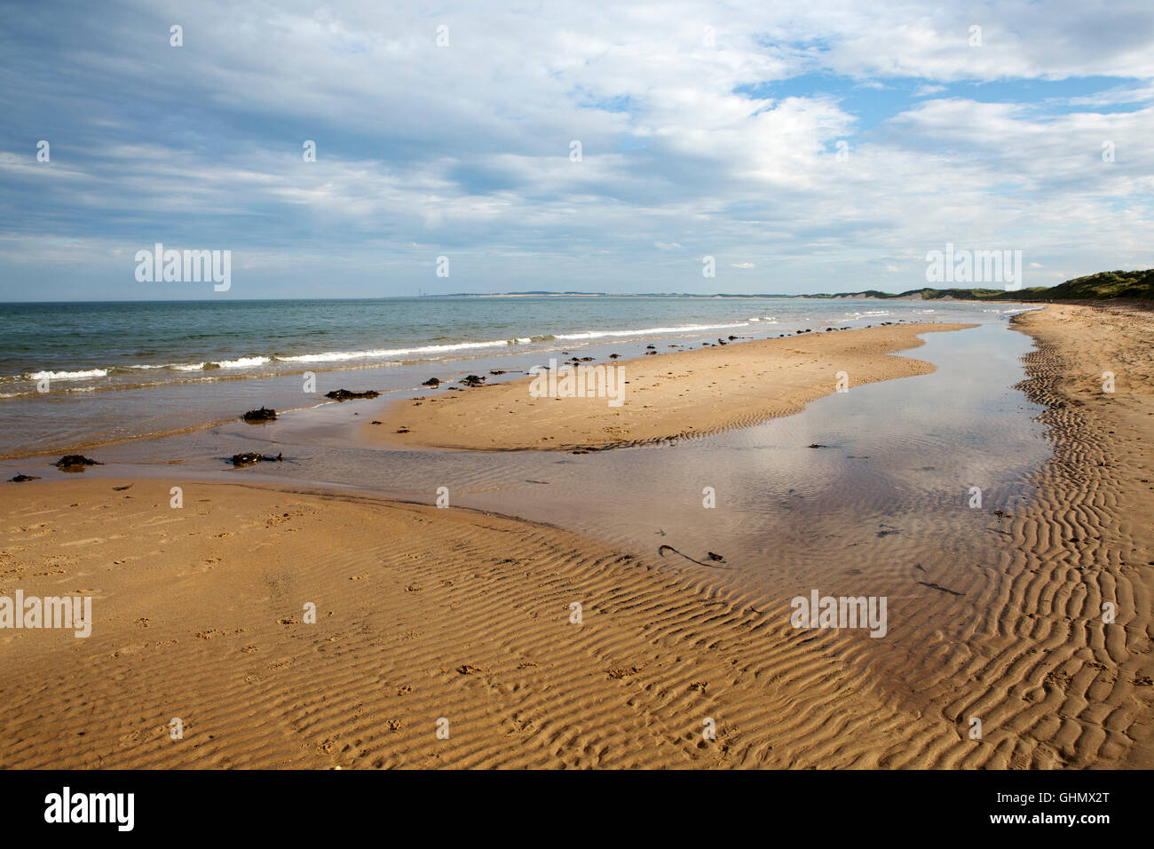 Modelli di onde sulla spiaggia di Druridge Bay in Northumberland, Inghilterra. Il mare del Nord giri sulla battigia. Foto Stock