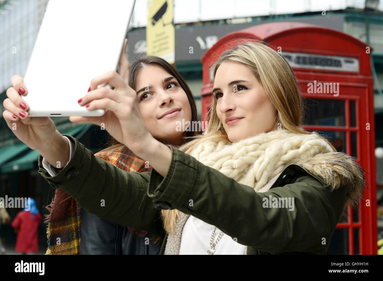 Ritratto di due giovani amiche tenendo selfie con la compressa in un viaggio insieme. Il concetto di turismo. All'esterno. Foto Stock