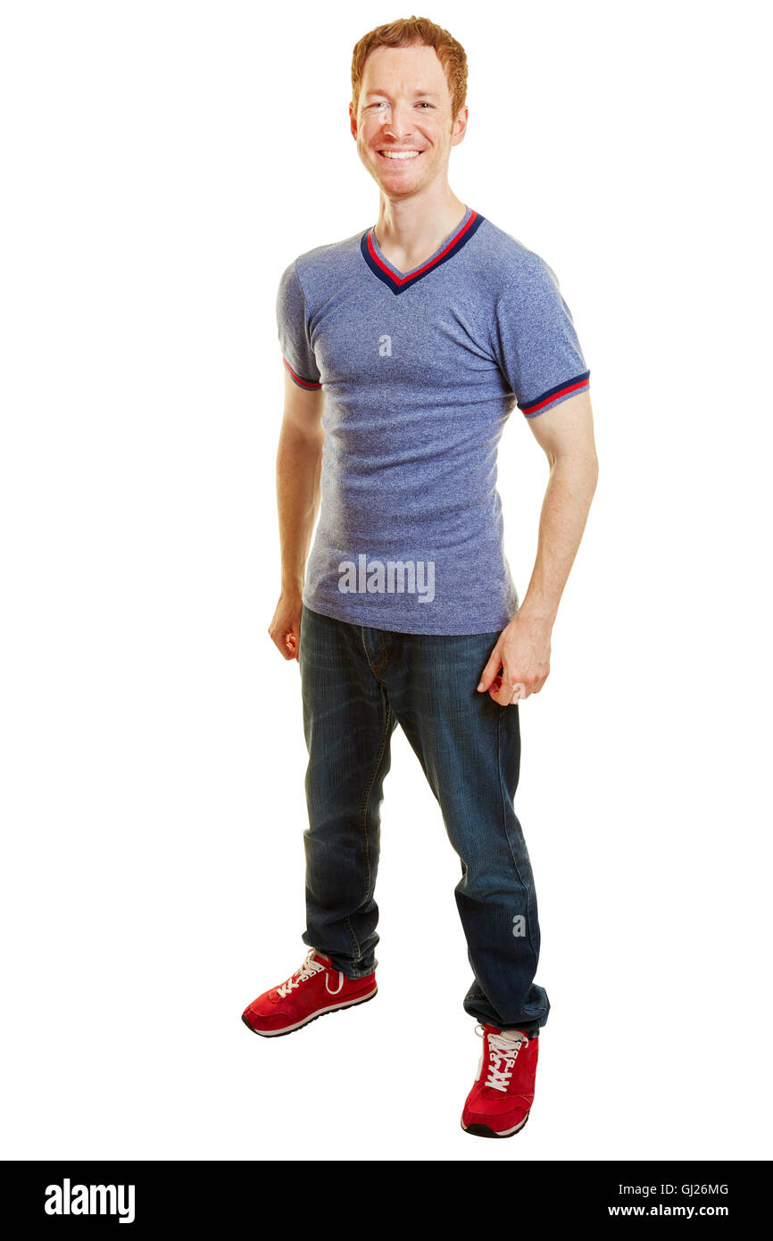 Sorridente atleta ancora in piedi con i jeans e scarpe da corsa Foto Stock