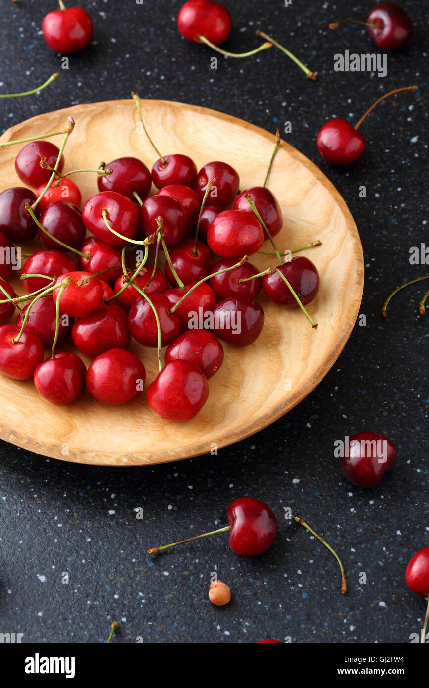 Dolce di ciliegia matura sulla piastra di legno, alimentari closeup Foto Stock