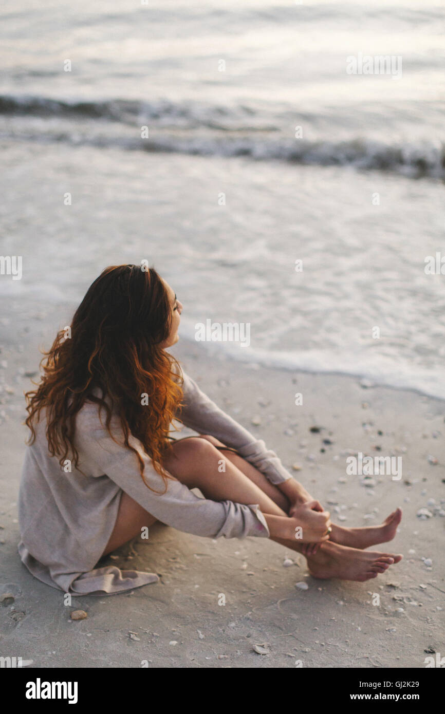 Donna fantasticando sulla spiaggia Foto Stock