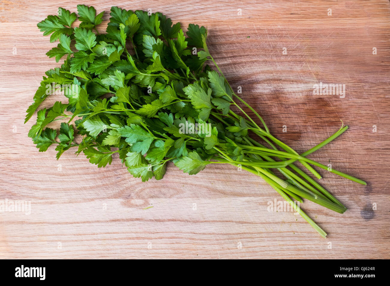 Prezzemolo fresco erbe sul tagliere di legno Foto Stock