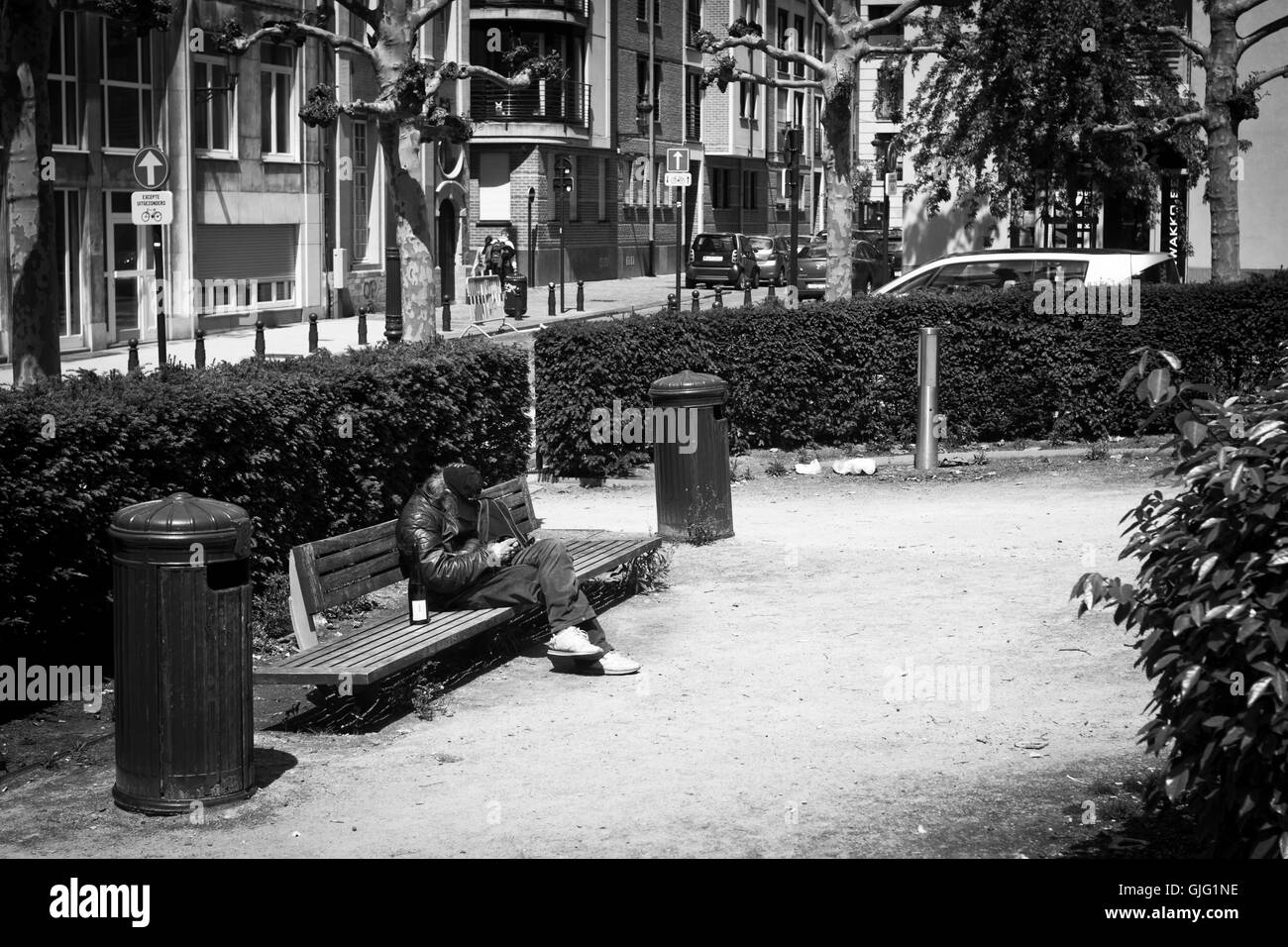 Un uomo senza tetto su un banco di lavoro a Bruxelles, in Belgio Foto Stock