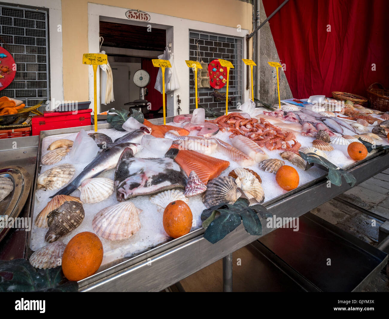 Bancarella vendendo il pesce appena pescato in una piazza veneziana o campo. Venezia, Italia. Foto Stock