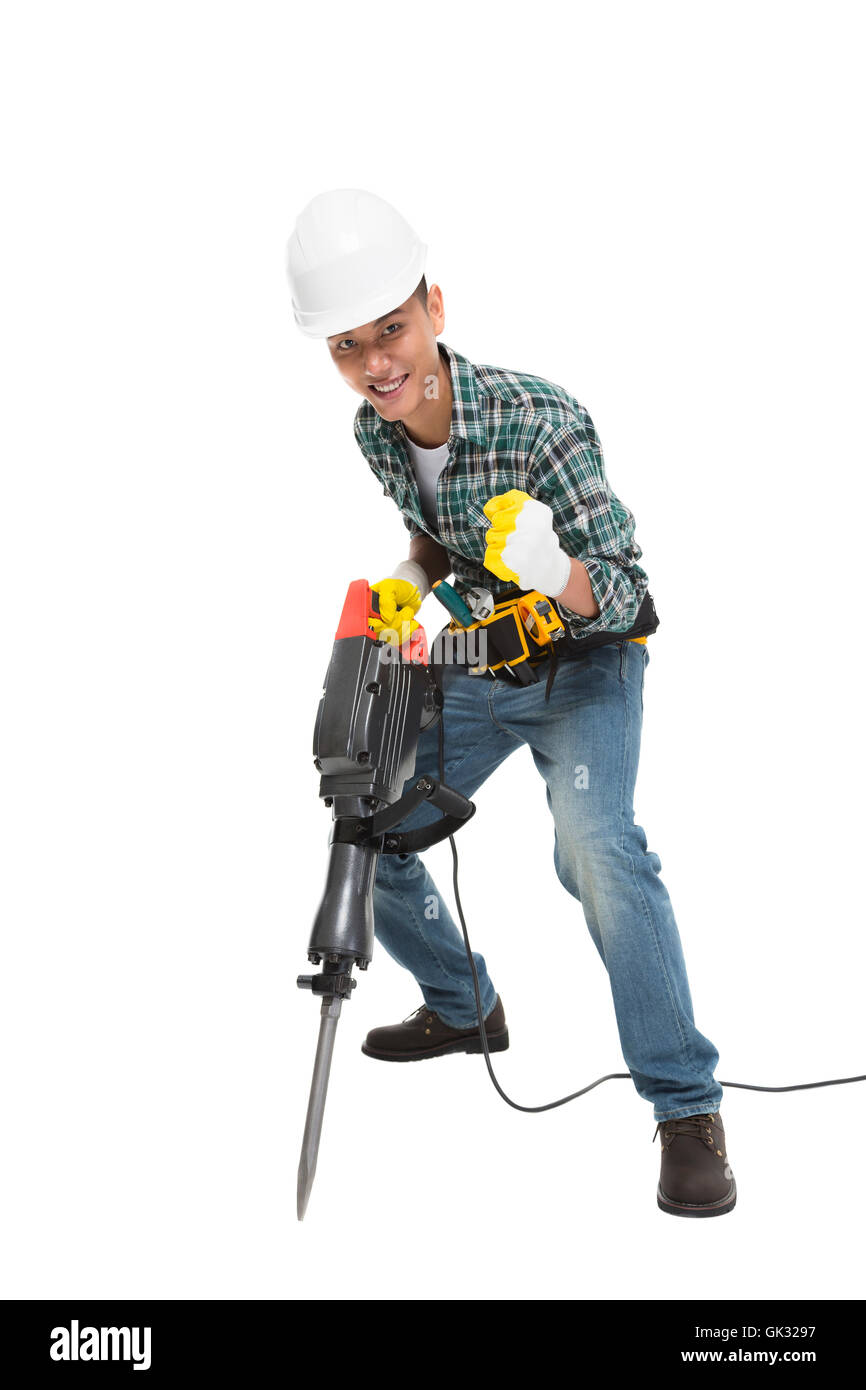 I giovani lavoratori edili prendere il trapano martello Foto Stock