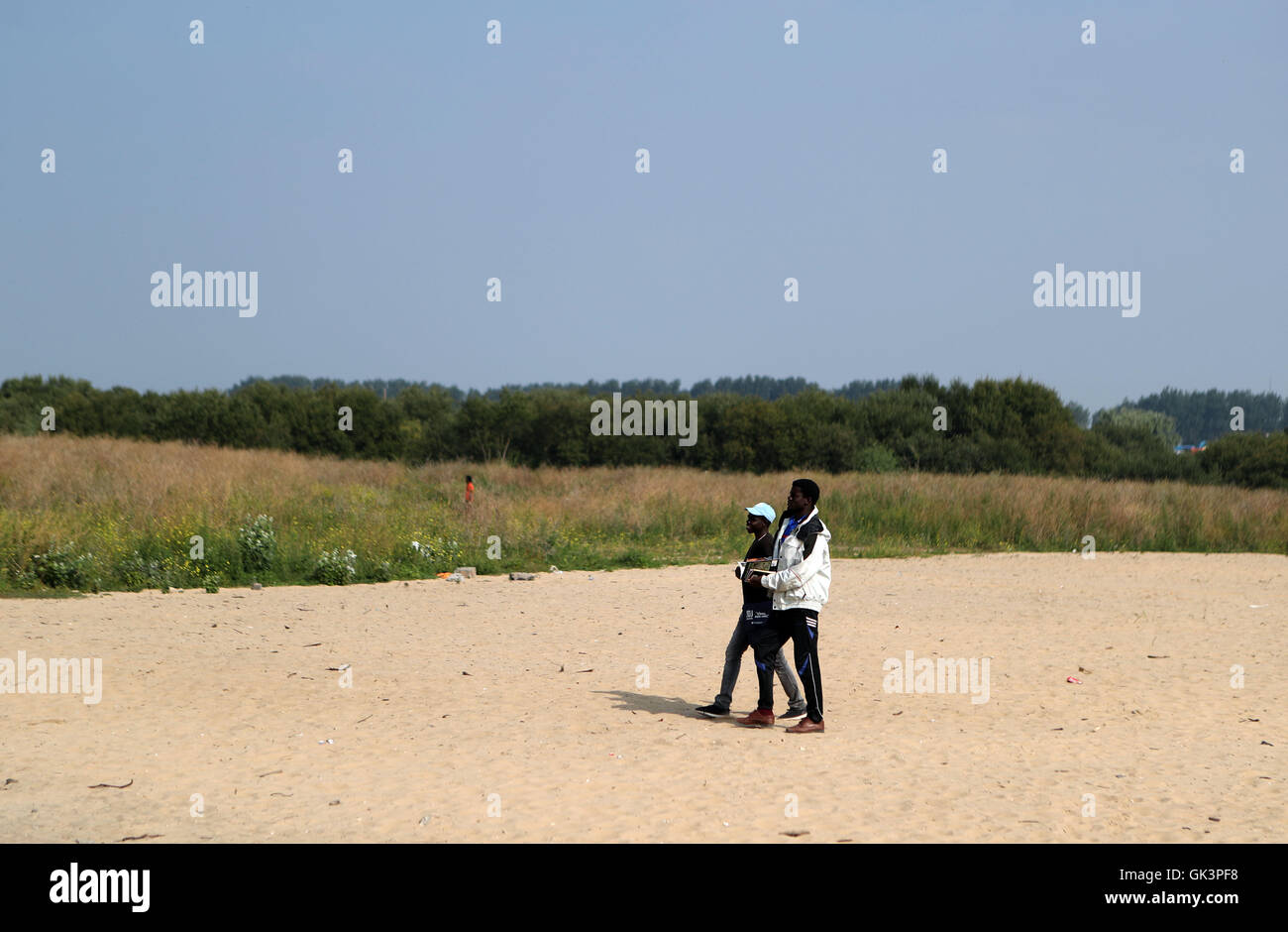 I rifugiati che vivono nella giungla campo nei pressi di Calais, Francia a piedi attraverso le tende dove una volta sorgeva prima di essere liquidati come autorità britanniche hanno viaggiato per la cittadina francese per una serie di colloqui con le loro controparti francesi sul modo migliore di affrontare il problema della lone i bambini migranti. Foto Stock