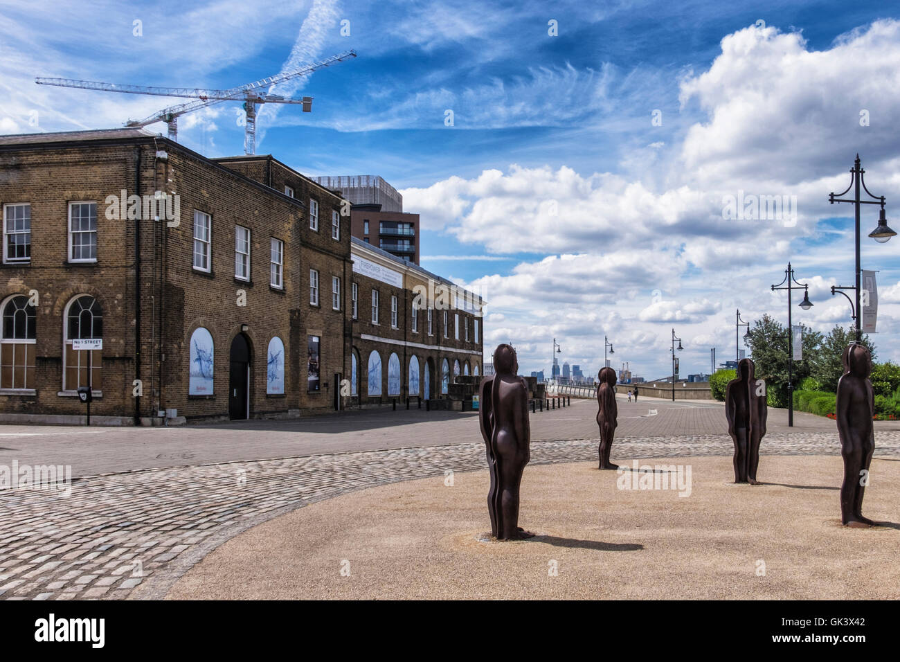 Woolwich, Londra.Regio Arsenale Riverside. La scultura, il gruppo da Peter Burke - 16 ghisa figure e vecchio edificio dell'ARSENAL Foto Stock