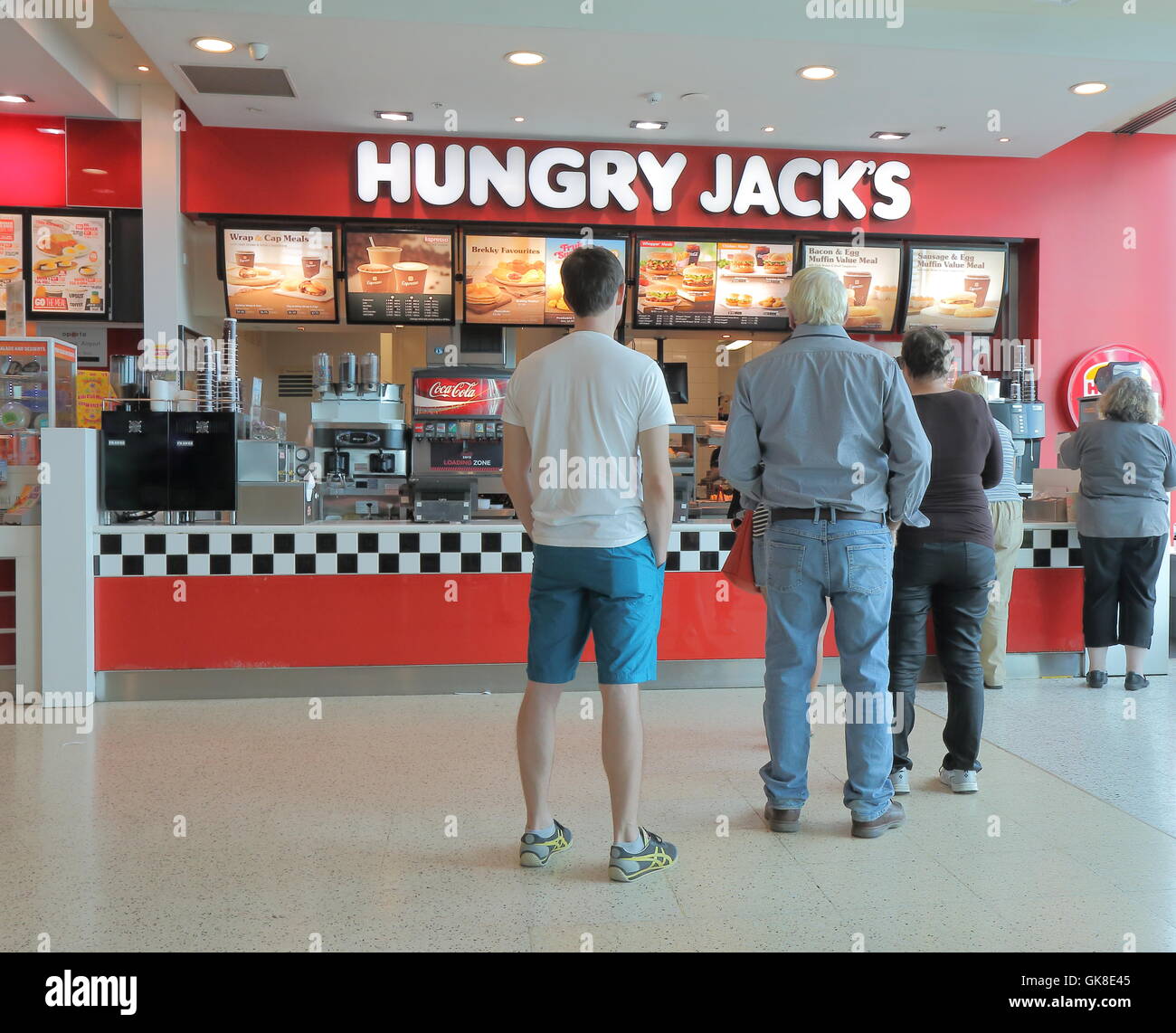 La gente in coda Hungry Jacks fast food Foto Stock