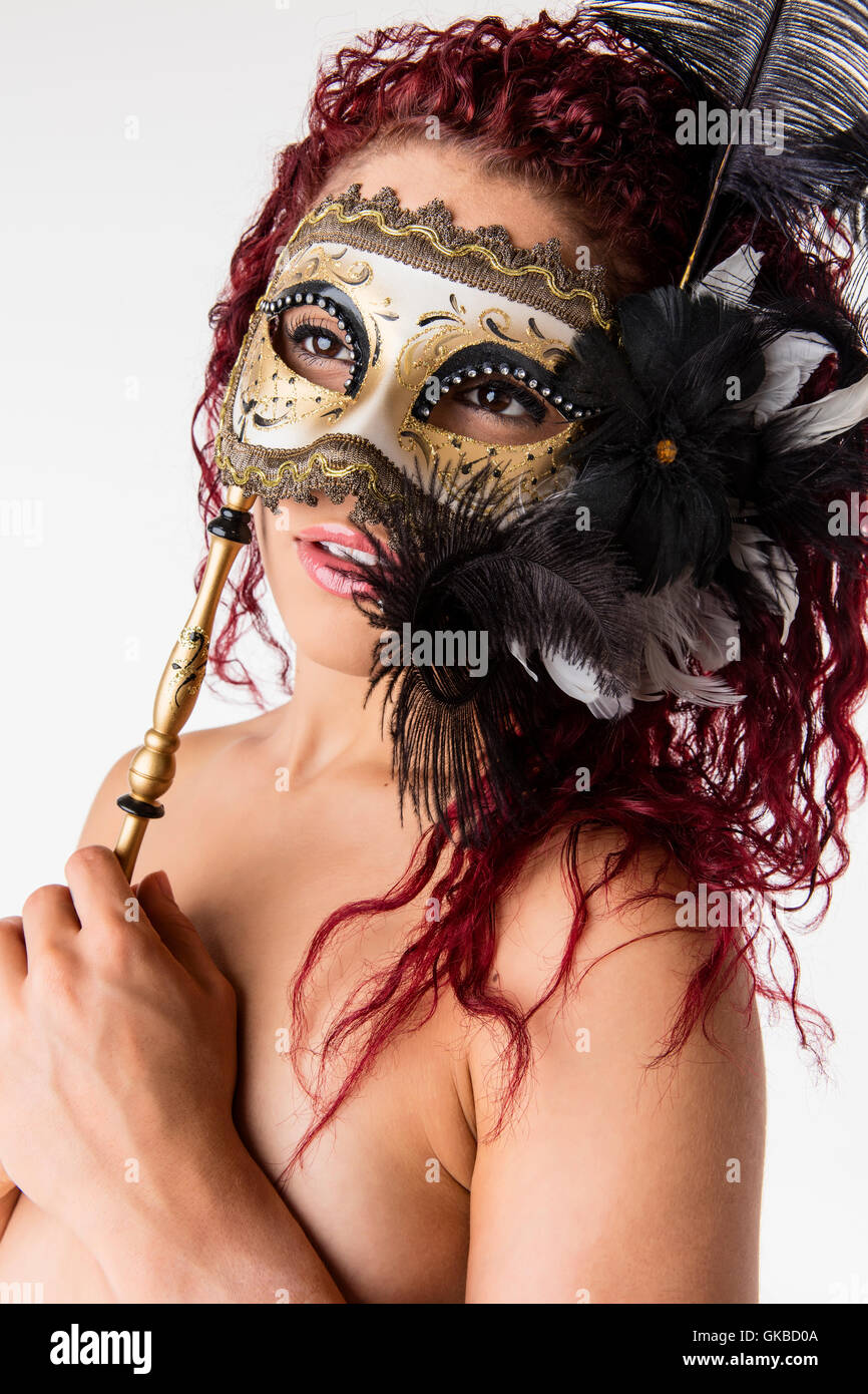 Giovani redhead con una maschera masquerade in studio, Virginia Beach, Foto Stock