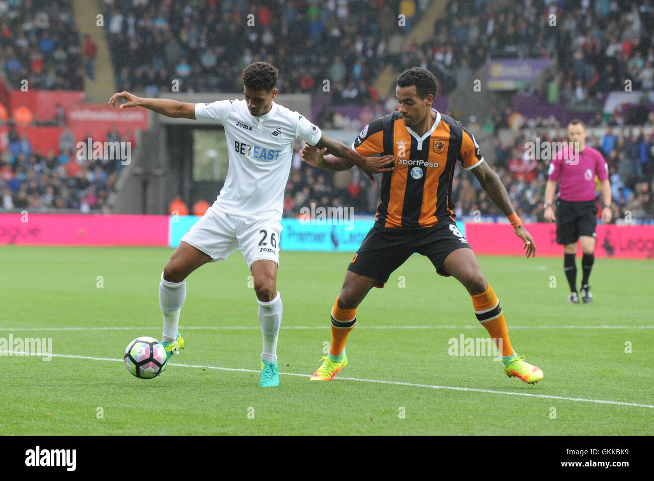 Swansea City è Kyle Naughton (sinistra) e Hull City's Tom Huddlestone in azione durante il match di Premier League al Liberty Stadium, Swansea. Foto Stock