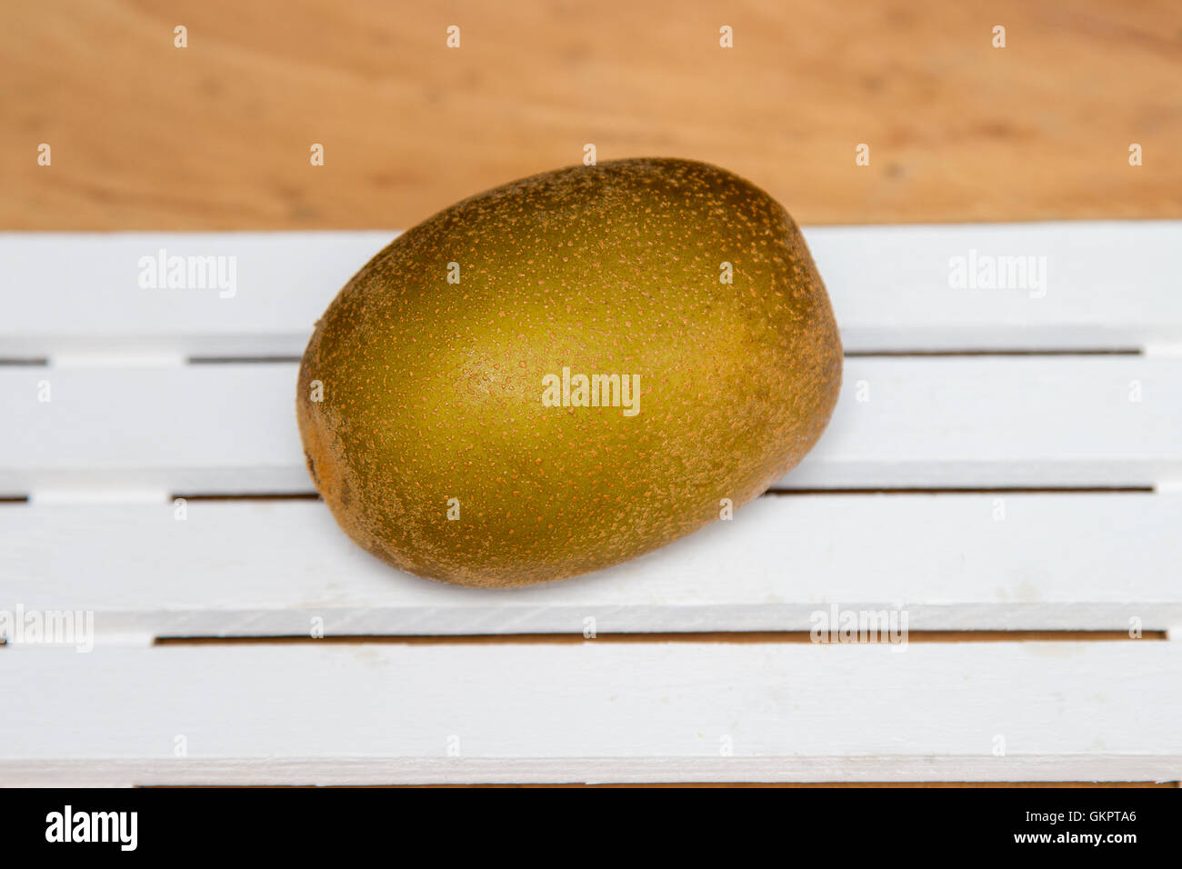 Close-up. Kiwi giallo su uno sfondo di legno. Foto Stock
