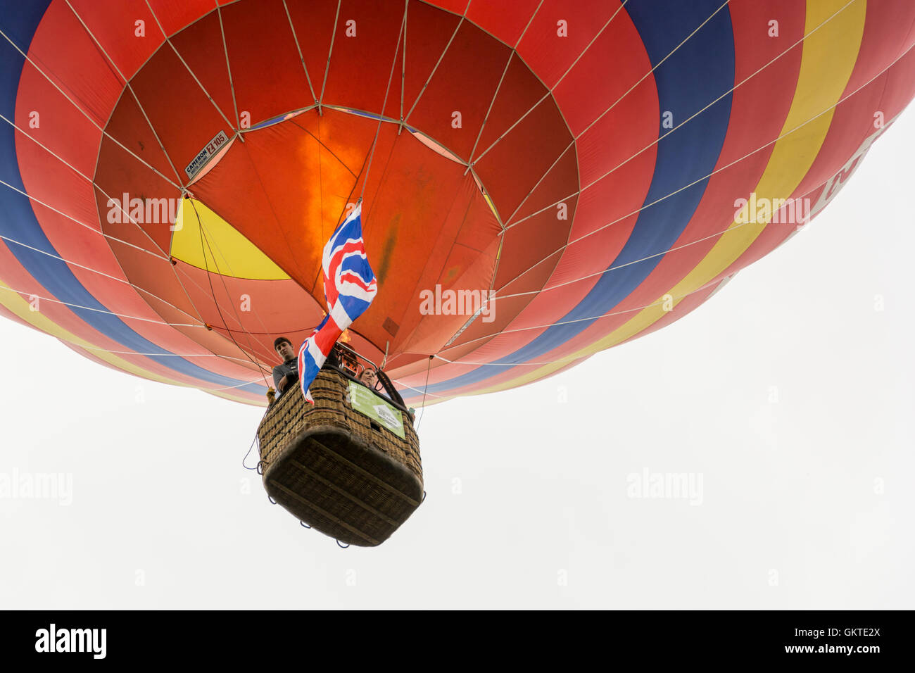In mongolfiera ad aria calda passa sopra la testa con il suo bruciatore sul presso la trentottesima annuale di Bristol International Balloon Fiesta Foto Stock