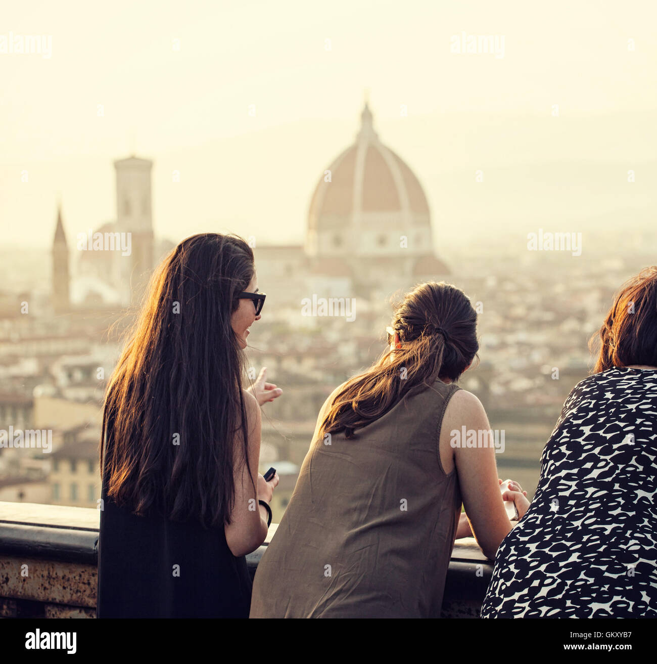 La gente al tramonto guardando il panorama di Firenze in un giorno di estate da Piazzale Michelangelo. Foto Stock