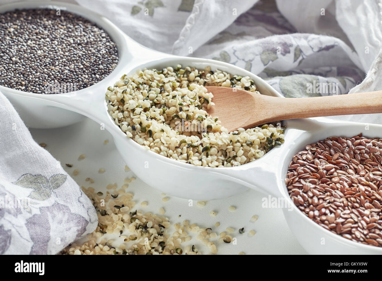 La canapa, lino e chia semi in vaso su sfondo bianco. Vegan fonti di Omega 3 Foto Stock