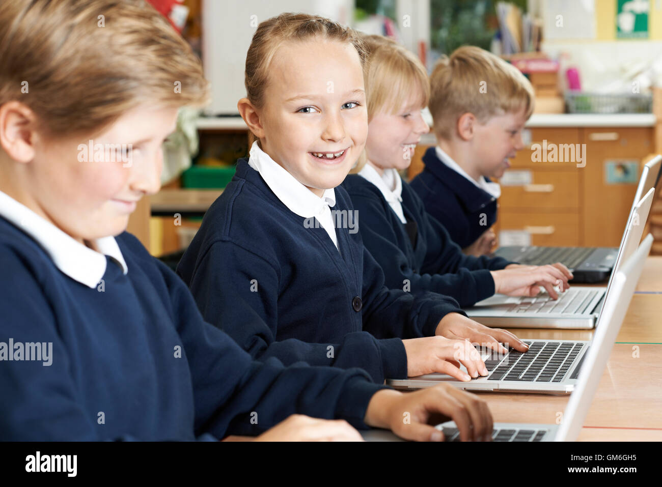 Un gruppo di bambini di scuola elementare in Classe Computer Foto Stock