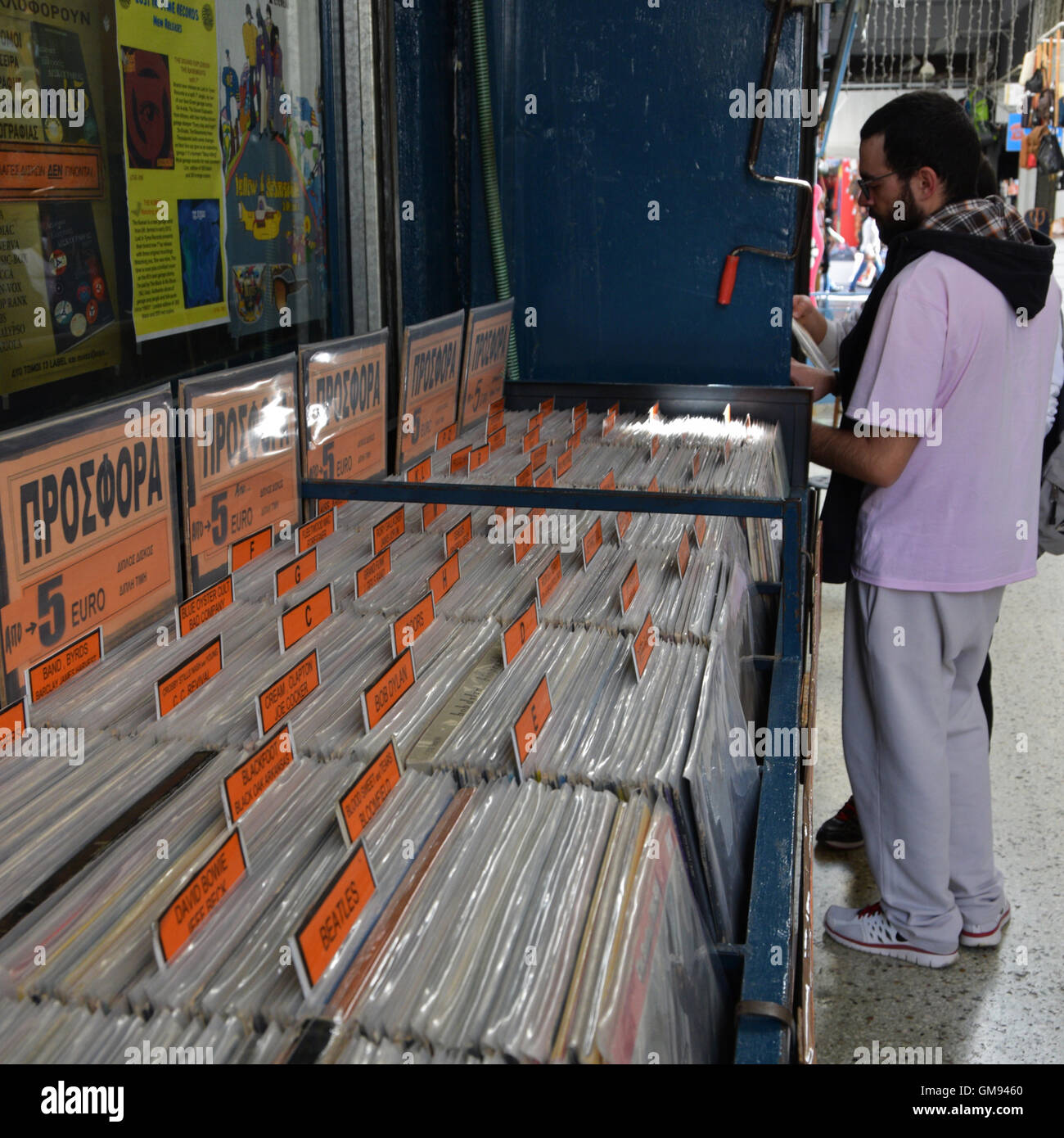 La gente di sfogliare la musica rock sezione in vinile usato record store. Foto Stock