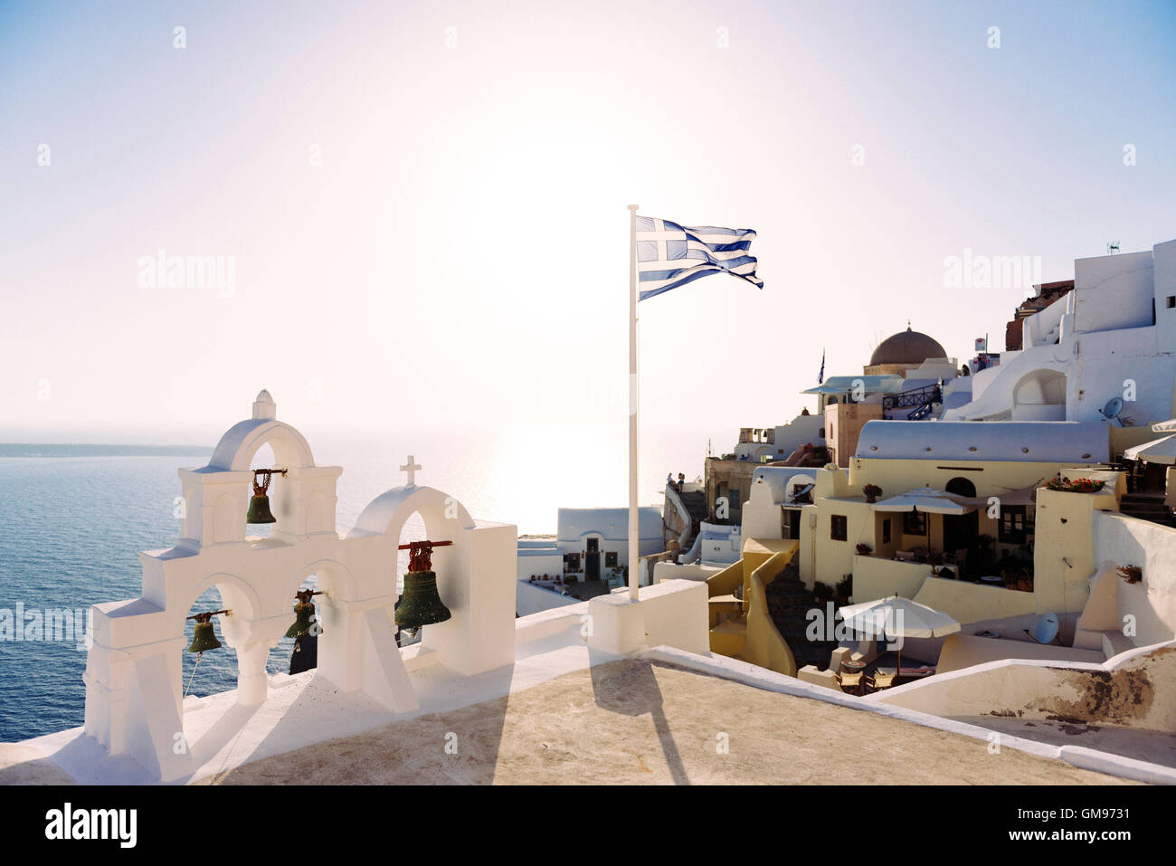 Grecia SANTORINI, Oia, bandiera greca sventolare su una chiesa al tramonto Foto Stock