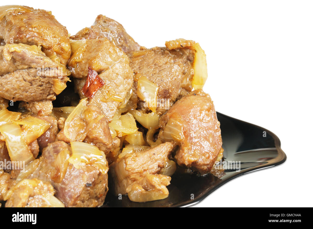 Stufato con cipolle su una piastra. Foto Stock