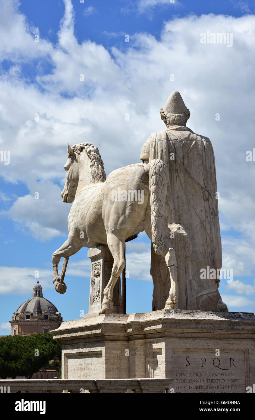 Antica statua romana di Dioskouri contro il cielo nuvoloso, sul Campidoglio a Roma Foto Stock